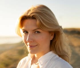 smiley blond hair lady at the beach